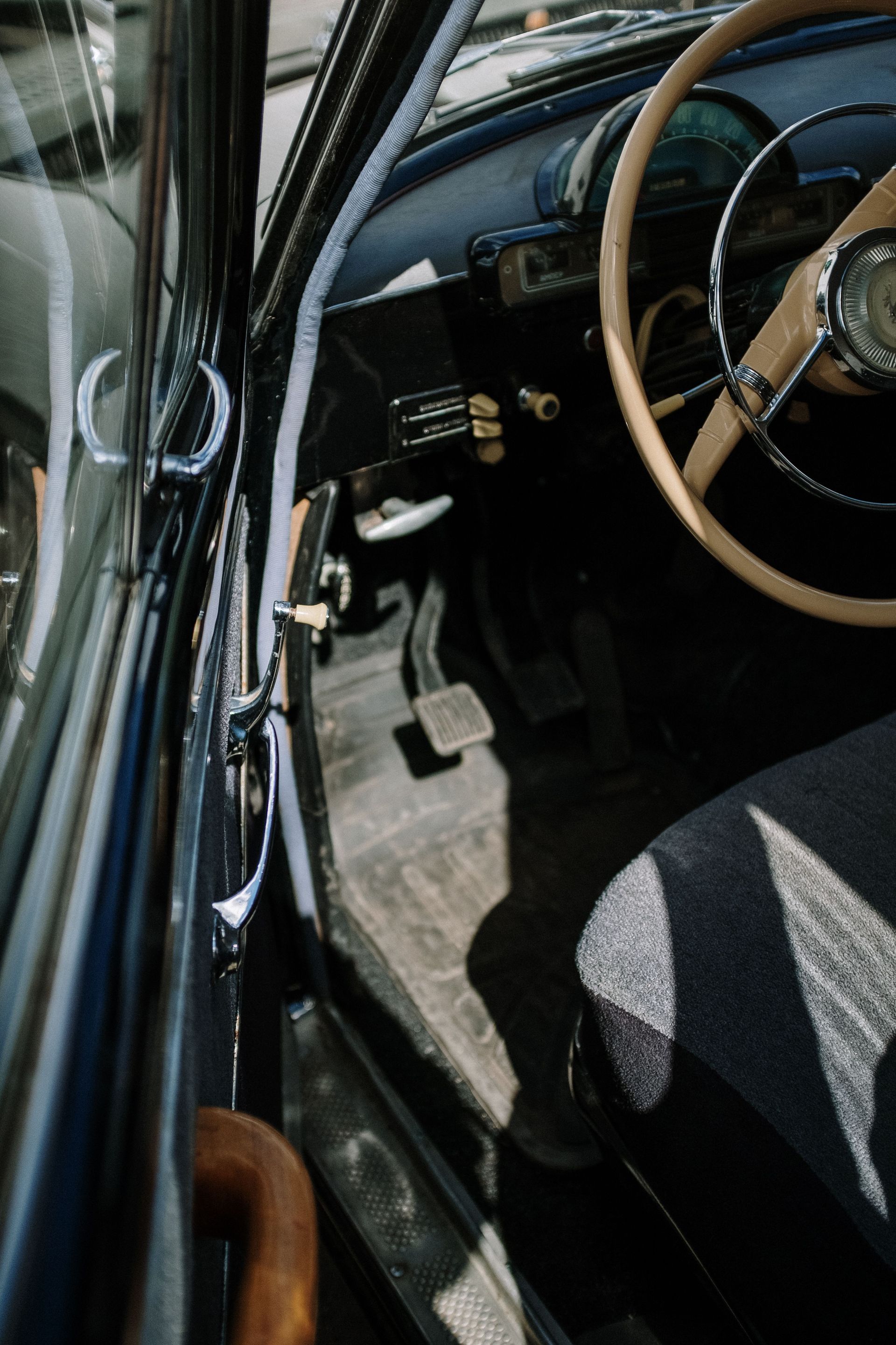 Close-up of a vintage car interior showcasing classic design elements and craftsmanship.